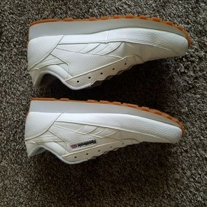 White Reebok Classics with gum bottom.
